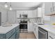 Bright kitchen features stainless appliances, white subway tile backsplash, and island with a blue base at 5301 Night Heron Dr, Wake Forest, NC 27587