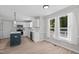 An open kitchen with white cabinets, stainless steel appliances, and an island with blue base at 5301 Night Heron Dr, Wake Forest, NC 27587