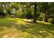 An expansive backyard includes a storage shed and large propane tank at 5504 Balsam Pl, Raleigh, NC 27603
