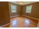 Cozy bedroom featuring hardwood floors, ceiling fan, and neutral colors at 5504 Balsam Pl, Raleigh, NC 27603