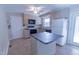 Functional kitchen with island, tile floors, and essential appliances at 5504 Balsam Pl, Raleigh, NC 27603