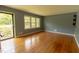 Sun-lit living room boasting hardwood floors and a large window at 5504 Balsam Pl, Raleigh, NC 27603