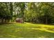 The home has a storage shed situated in a lush and green landscape at 5504 Balsam Pl, Raleigh, NC 27603
