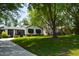 Landscaped yard surrounds this charming home with beautiful lawn and mature trees at 5617 Groomsbridge Ct, Raleigh, NC 27612