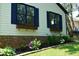 Charming home exterior featuring blue shutters, brick accents, flower boxes, and landscaped flowerbeds at 5617 Groomsbridge Ct, Raleigh, NC 27612