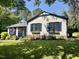 Inviting home with blue trim, shutters, flower boxes, and a well-manicured lawn shaded by mature trees at 5617 Groomsbridge Ct, Raleigh, NC 27612