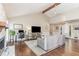 This bright and airy living room features a vaulted ceiling and fireplace at 5617 Groomsbridge Ct, Raleigh, NC 27612
