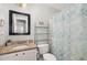 This bathroom showcases a decorative shower curtain, a shelving unit, and a granite countertop at 5817 Seward Dr, Knightdale, NC 27545
