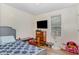 Cozy bedroom featuring hardwood floors, a desk, and a window for natural light at 5817 Seward Dr, Knightdale, NC 27545