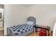 The bedroom features wood-look floors, a gray bed frame and a small desk with red chair at 5817 Seward Dr, Knightdale, NC 27545