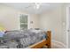 Bedroom featuring a ceiling fan, a window, and a large wooden bed frame at 5817 Seward Dr, Knightdale, NC 27545