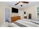 Comfortable bedroom featuring a TV, ceiling fan, and an adjacent bathroom for convenience and relaxation at 5817 Seward Dr, Knightdale, NC 27545