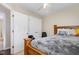 Bedroom featuring a ceiling fan, a closet with double doors, and a large wooden bed frame at 5817 Seward Dr, Knightdale, NC 27545