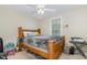 Bedroom featuring a ceiling fan, a window, and a large wooden bed frame at 5817 Seward Dr, Knightdale, NC 27545