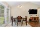 Inviting dining area featuring a modern light fixture and sliding glass door for bright, natural light at 5817 Seward Dr, Knightdale, NC 27545