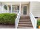 Inviting front porch with brick steps and white railing at 5817 Seward Dr, Knightdale, NC 27545