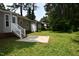 Backyard featuring a patio and lush lawn, surrounded by tall trees at 5949 Sandy Run, Knightdale, NC 27545