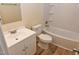 Bathroom featuring a light wood-look floor, white fixtures and vanity, and shower and tub combo at 5949 Sandy Run, Knightdale, NC 27545