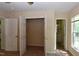 Bedroom with large open closet, neutral walls and carpet, and doors to bathroom and hallway at 5949 Sandy Run, Knightdale, NC 27545