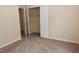 Bedroom features neutral walls, carpet, and a closet with open doors at 5949 Sandy Run, Knightdale, NC 27545