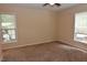 Spacious bedroom with two large windows and neutral carpeting at 5949 Sandy Run, Knightdale, NC 27545