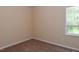 Bedroom features neutral walls and carpet, brightened by a large window at 5949 Sandy Run, Knightdale, NC 27545