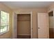 Bedroom features neutral walls, carpet, a window, and closet with open doors at 5949 Sandy Run, Knightdale, NC 27545