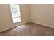 Cozy bedroom with neutral walls and carpet, brightened by a large window at 5949 Sandy Run, Knightdale, NC 27545