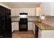 Modern kitchen with white cabinets, granite countertops, and stainless steel appliances at 5949 Sandy Run, Knightdale, NC 27545