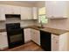 Updated kitchen featuring white cabinets, granite countertops, stainless sink and backsplash at 5949 Sandy Run, Knightdale, NC 27545