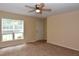 Bright living room with carpet, ceiling fan and large window providing natural light at 5949 Sandy Run, Knightdale, NC 27545