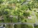 Aerial view of a neighborhood with multiple ponds and lush green trees at 6411 Pondview Ln, Durham, NC 27712