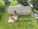 Aerial view of the brick home featuring a spacious backyard, wooden deck, and a charming brick chimney at 6411 Pondview Ln, Durham, NC 27712