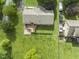 Aerial view of the property with a large backyard, a wooden deck and patio area, and driveway at 6411 Pondview Ln, Durham, NC 27712