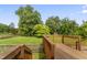Wooden back deck overlooking a well-manicured lawn and mature trees, creating a private outdoor space at 6411 Pondview Ln, Durham, NC 27712
