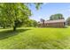 Lush backyard view with mature trees and ample space for activities at 6411 Pondview Ln, Durham, NC 27712