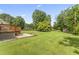 Backyard features a deck and patio area, overlooking a large grassy area at 6411 Pondview Ln, Durham, NC 27712
