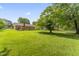 Spacious backyard with lush green lawn and mature trees, great for recreation at 6411 Pondview Ln, Durham, NC 27712
