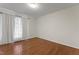 An empty bedroom showcasing hardwood floors and natural light from the window at 6411 Pondview Ln, Durham, NC 27712