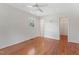 Bright bedroom with hardwood floors, a ceiling fan, and a window offering natural light at 6411 Pondview Ln, Durham, NC 27712