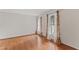 Spacious bedroom with hardwood floors and three large windows providing natural light at 6411 Pondview Ln, Durham, NC 27712