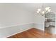 Spacious dining area with hardwood floors and natural light streaming through a window at 6411 Pondview Ln, Durham, NC 27712