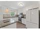 Bright kitchen with white cabinets, stainless steel appliances, and an island with granite countertop at 6411 Pondview Ln, Durham, NC 27712