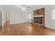 Living room featuring a brick fireplace, hardwood floors, and neutral color scheme at 6411 Pondview Ln, Durham, NC 27712