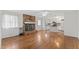 Open living space with a brick fireplace and seamless transition to a bright, modern kitchen at 6411 Pondview Ln, Durham, NC 27712