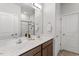 Modern bathroom with double sink vanity, large mirror, and a glass enclosed shower at 6512 Bunker Hill Dr, Raleigh, NC 27610