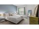 Bright bedroom featuring a queen bed, large windows, and light-colored walls at 6512 Bunker Hill Dr, Raleigh, NC 27610