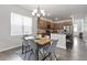 Dining area features a wooden table, gray chairs, and a stylish chandelier above at 6512 Bunker Hill Dr, Raleigh, NC 27610