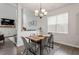 Dining area features a wooden table, gray chairs, and a stylish chandelier above at 6512 Bunker Hill Dr, Raleigh, NC 27610