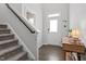 Inviting entryway featuring a staircase, console table, and stylish decor at 6512 Bunker Hill Dr, Raleigh, NC 27610